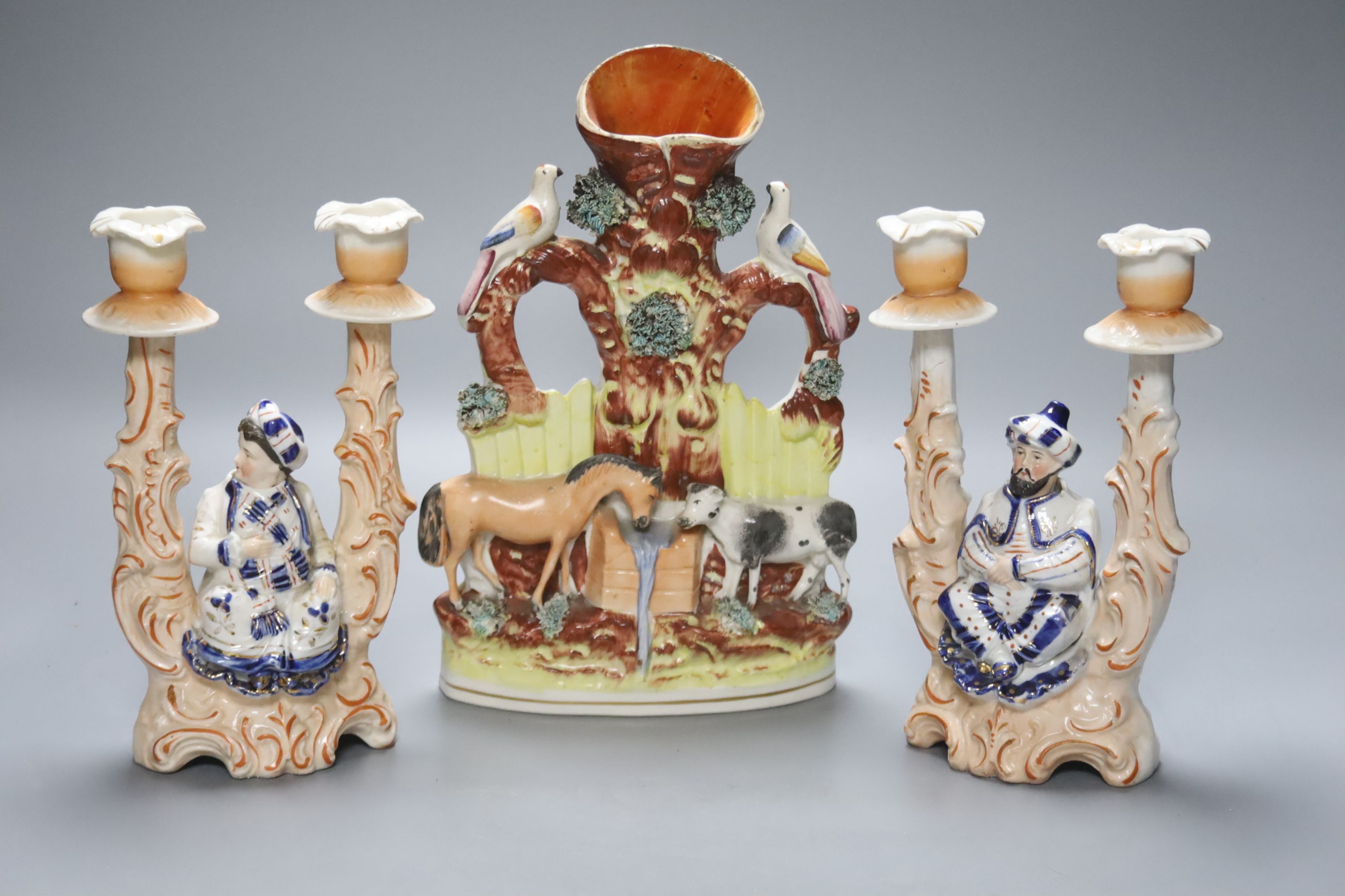 A Staffordshire flatback group of a horse and cow and a pair of novelty 19th century Continental porcelain nodding figural candlesticks